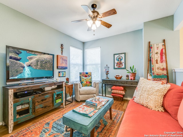 living room featuring wood-type flooring and ceiling fan