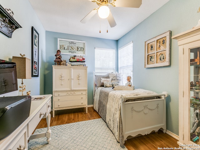 bedroom with ceiling fan and light hardwood / wood-style flooring