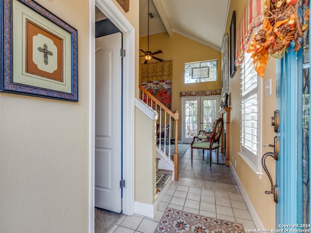 tiled foyer entrance with french doors, vaulted ceiling with beams, and ceiling fan