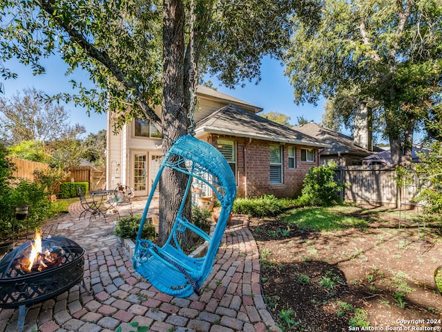 back of house featuring a patio and a fire pit