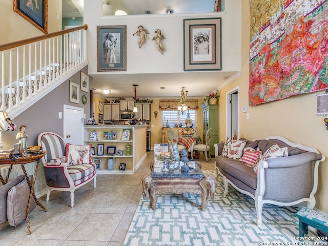 living room featuring a high ceiling, light tile patterned floors, and a notable chandelier