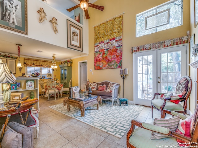 living room with a high ceiling, french doors, light tile patterned floors, and ceiling fan