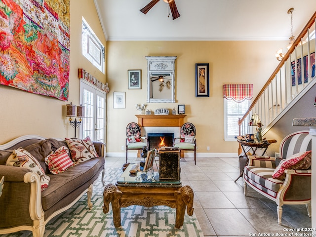 living room featuring a fireplace, tile patterned flooring, a healthy amount of sunlight, and crown molding