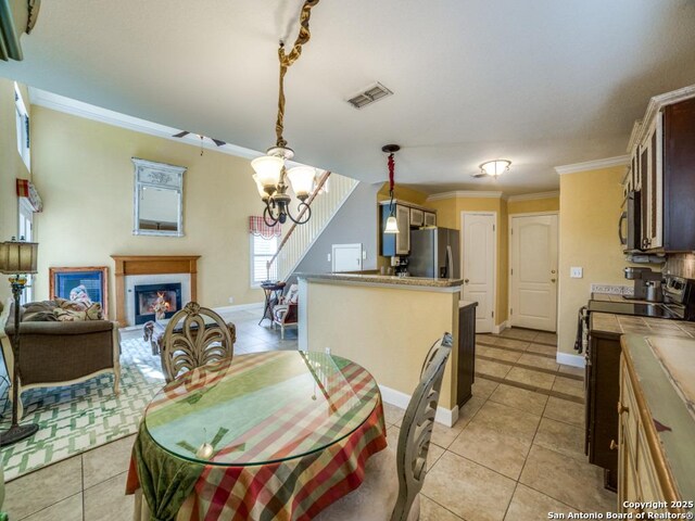 16 Pembroke Ln, San Antonio, TX 78240 - dining area with light tile patterned floors, a chandelier, ornamental molding, baseboards, and a fireplace