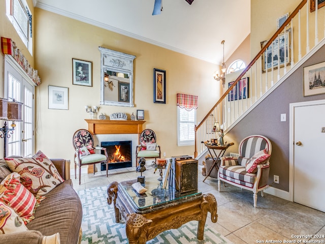 tiled living room featuring a high ceiling, a healthy amount of sunlight, and crown molding