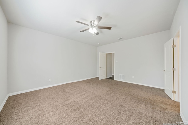 carpeted spare room featuring ceiling fan