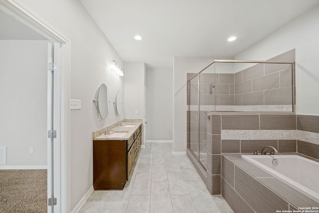 bathroom with plus walk in shower, vanity, and tile patterned floors