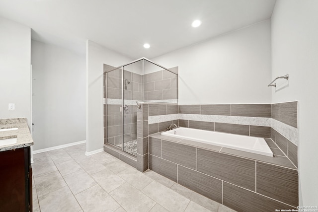 bathroom featuring shower with separate bathtub, vanity, and tile patterned flooring