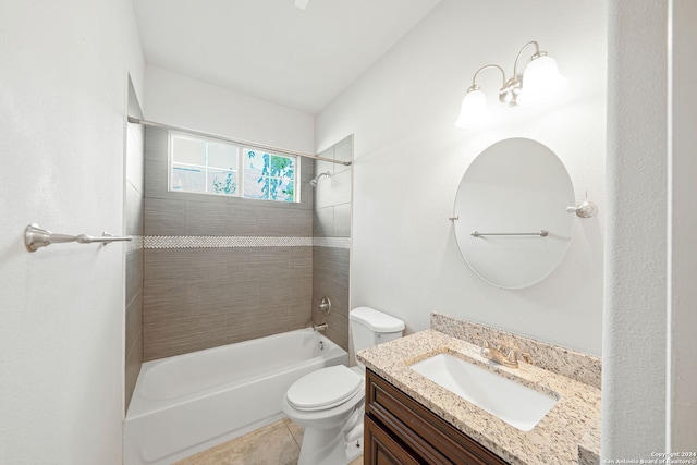 full bathroom featuring tile patterned flooring, vanity, toilet, and tiled shower / bath