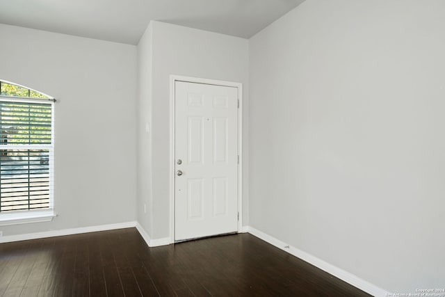 empty room with dark hardwood / wood-style floors