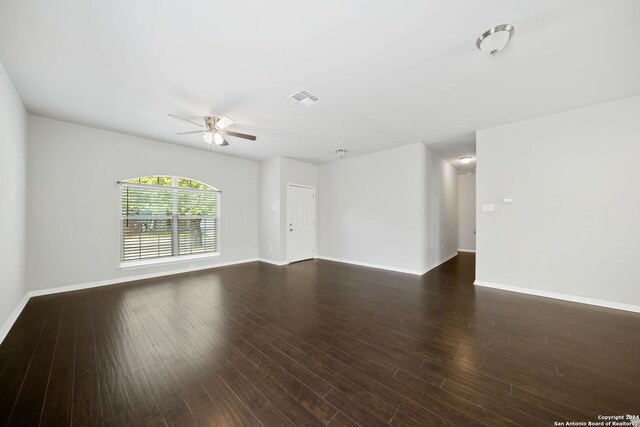 spare room with ceiling fan and dark hardwood / wood-style floors