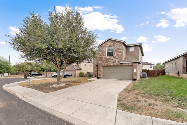 view of front of home with central air condition unit, a front yard, and a garage