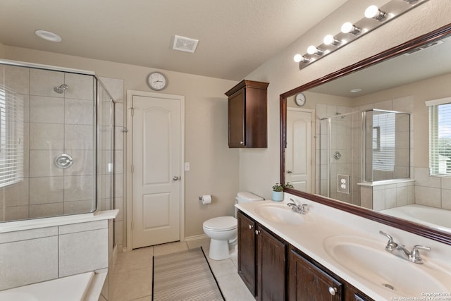 bathroom featuring toilet, tile patterned floors, a textured ceiling, vanity, and walk in shower