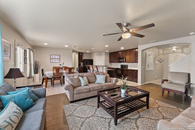 3922 Verde Bosque, San Antonio, TX 78223 - living area with light wood-style flooring, arched walkways, a textured ceiling, a ceiling fan, and recessed lighting