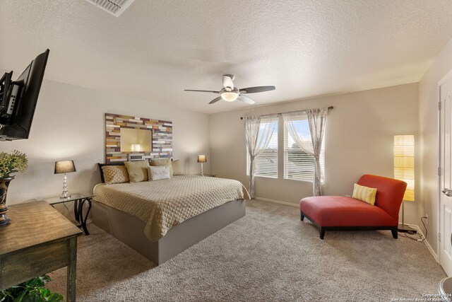 3922 Verde Bosque, San Antonio, TX 78223 - carpeted bedroom with baseboards, a textured ceiling, and a ceiling fan