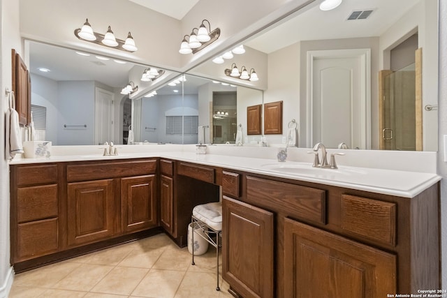 bathroom featuring tile patterned floors, vanity, and a shower with shower door