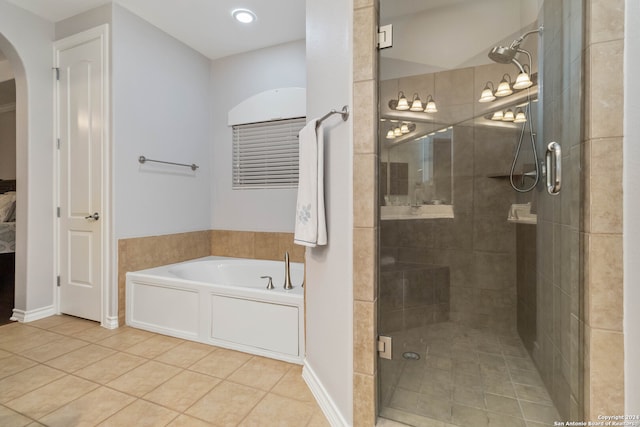 bathroom featuring independent shower and bath and tile patterned flooring