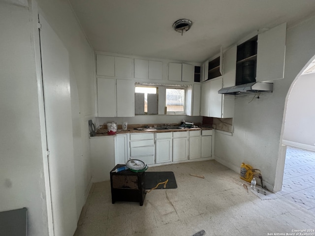 kitchen featuring white cabinetry and extractor fan