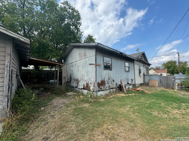 view of side of home with a lawn