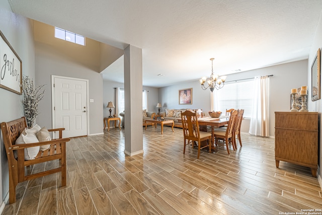 dining area with plenty of natural light and an inviting chandelier