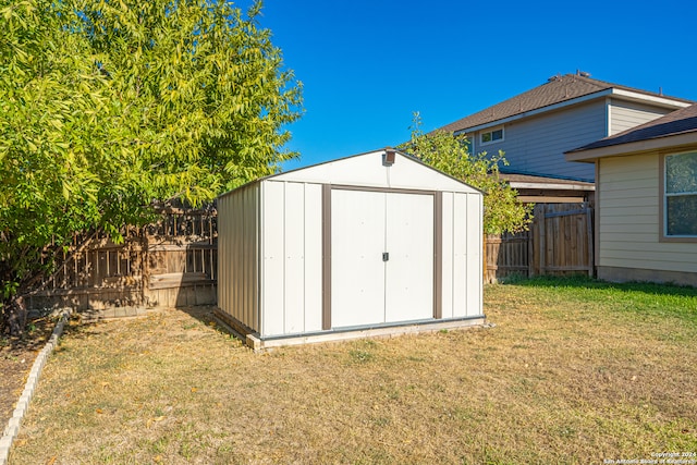 view of outbuilding with a lawn