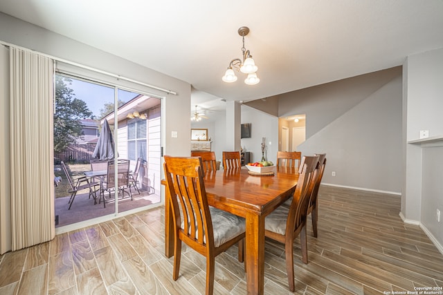 dining space with wood-type flooring and ceiling fan with notable chandelier