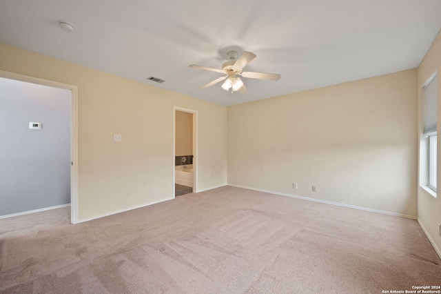 spare room with ceiling fan, carpet flooring, and baseboards