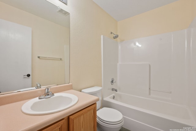 bathroom with toilet, vanity, and shower / tub combination