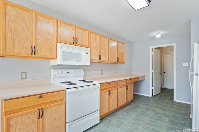 kitchen featuring white appliances, light brown cabinets, and light countertops