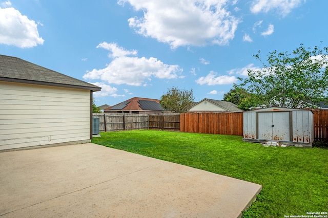 view of yard featuring a patio area and a storage unit