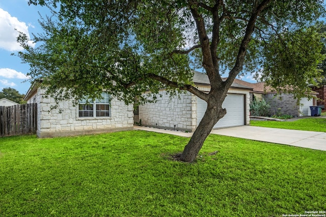 view of property hidden behind natural elements featuring concrete driveway and a garage