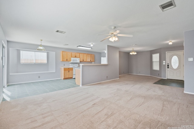 unfurnished living room featuring light carpet and ceiling fan with notable chandelier