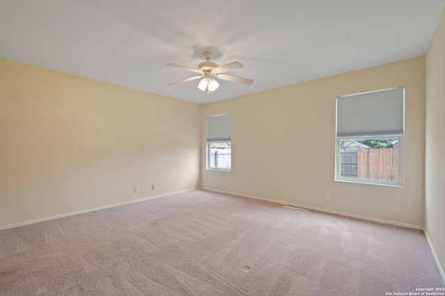 empty room with a ceiling fan, carpet flooring, and baseboards