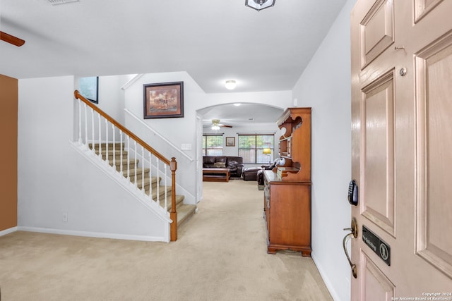 foyer with light colored carpet and ceiling fan