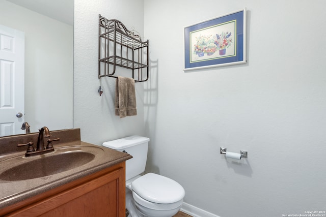 bathroom featuring toilet and vanity