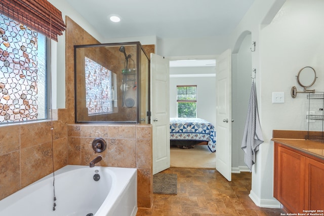 bathroom with independent shower and bath and vanity