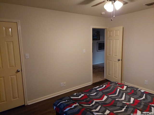 bedroom with dark wood-type flooring and ceiling fan