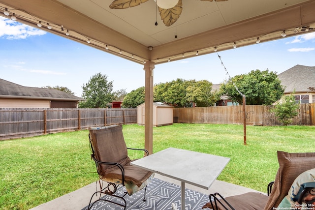 view of patio / terrace featuring a storage shed and ceiling fan