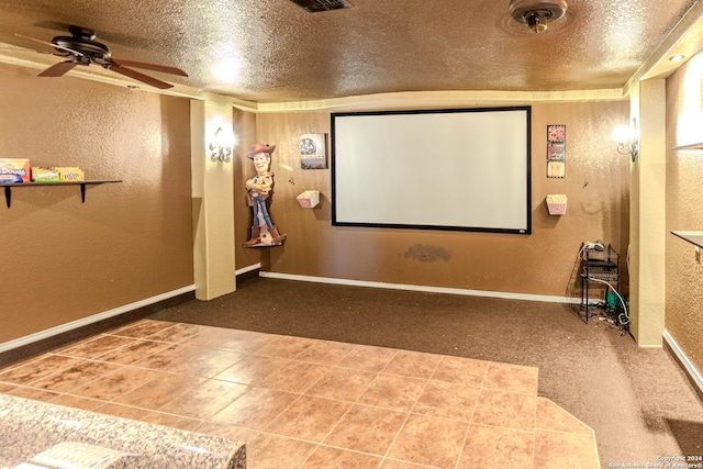 tiled home theater room featuring ceiling fan and a textured ceiling