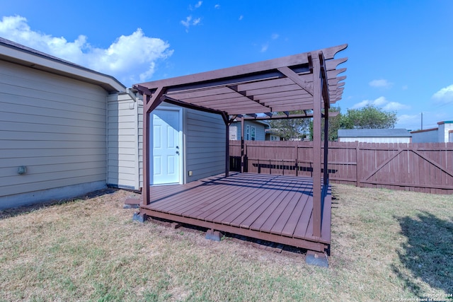 deck featuring a lawn and a pergola