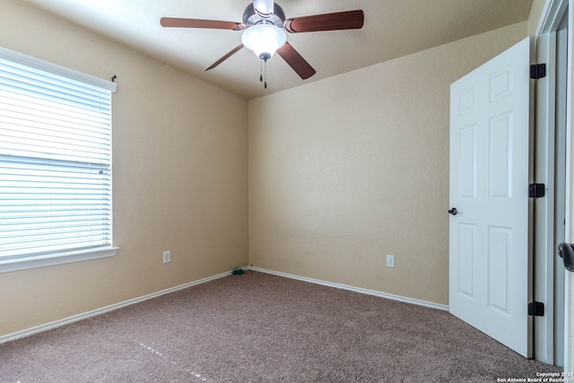 spare room with carpet flooring and ceiling fan