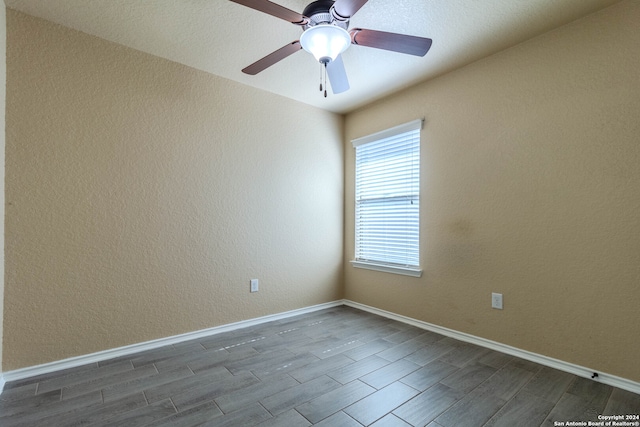 spare room with ceiling fan and dark hardwood / wood-style flooring