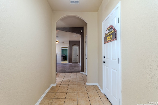 hall featuring light tile patterned flooring