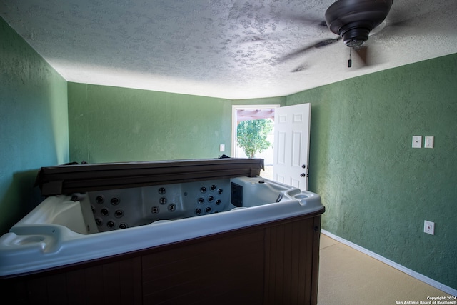 carpeted bedroom with a textured ceiling and ceiling fan