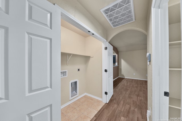 laundry room featuring hookup for a washing machine, light hardwood / wood-style floors, and electric dryer hookup