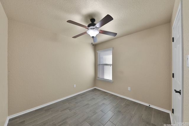 spare room with ceiling fan, a textured ceiling, and hardwood / wood-style flooring