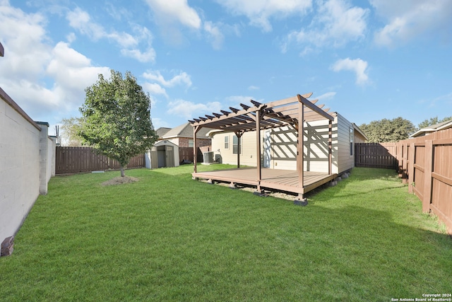 view of yard with a deck, a pergola, and a storage shed