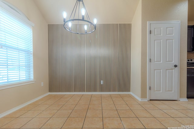 unfurnished dining area featuring light tile patterned flooring and an inviting chandelier