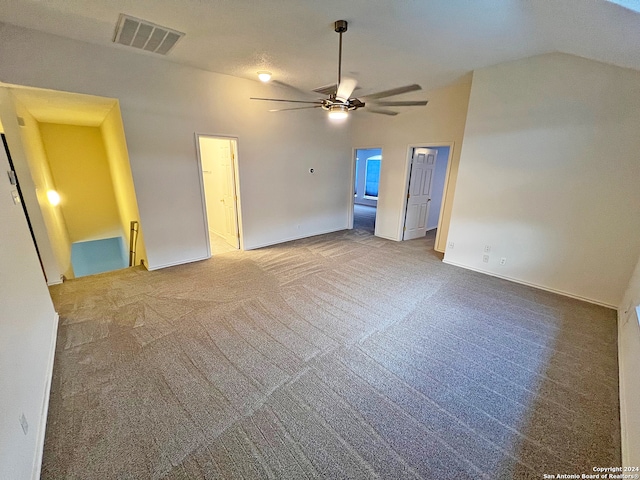 spare room with lofted ceiling, carpet, and ceiling fan