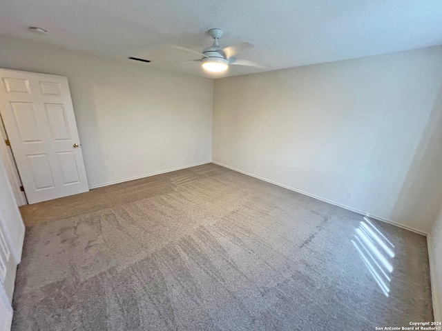 carpeted empty room featuring ceiling fan